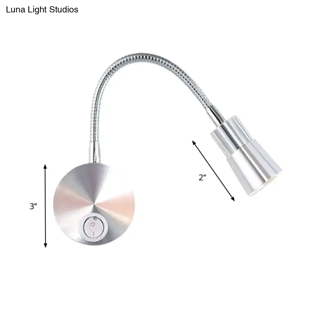 Silver metallic gooseneck reading lamp with flexible articulated arm and mini metal shade for bedroom use