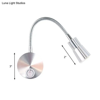Silver metallic gooseneck reading lamp with flexible articulated arm and mini metal shade for bedroom use
