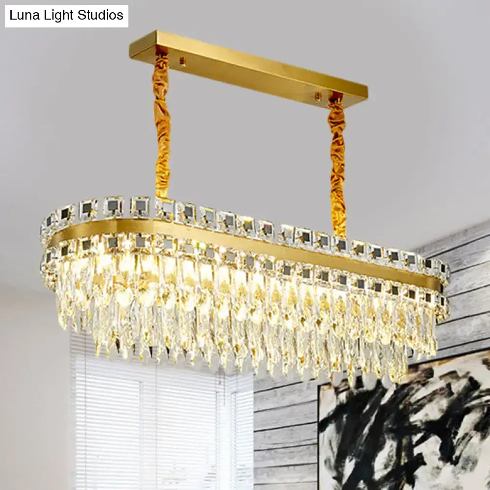 Gold-finished oval LED crystal light fixture with cascading clear droplets for modern dining room decor