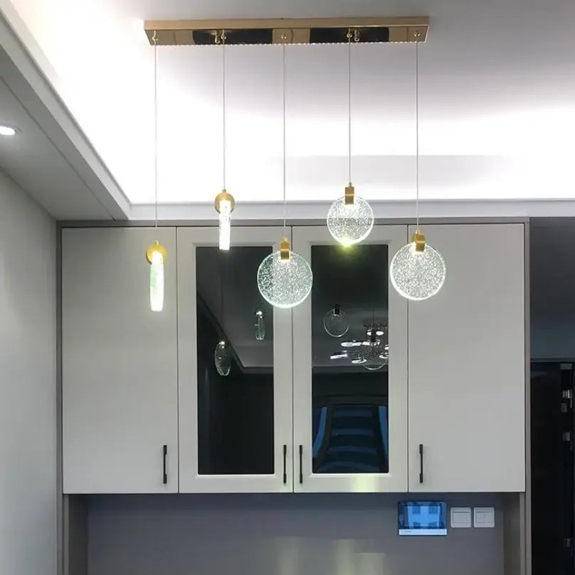 DecorBites™ led crystal pendant light with clear textured glass globes and gold fixtures for bedroom and bathroom use