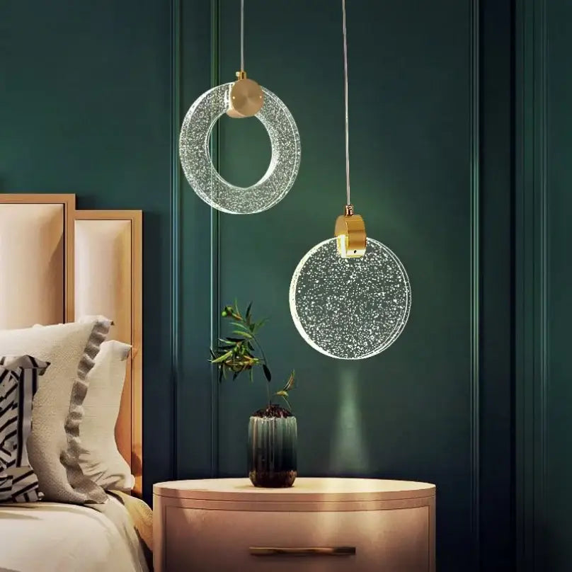 Two elegant gold-toned led crystal pendant lights with sparkling glass design for bedroom and bathroom decor