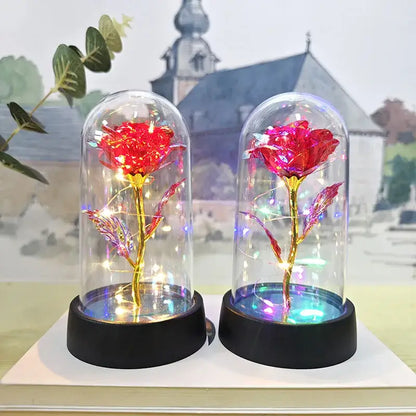 Two illuminated red metallic roses in glass domes with black bases decorbites™ eternal rose light for valentine’s day and weddings