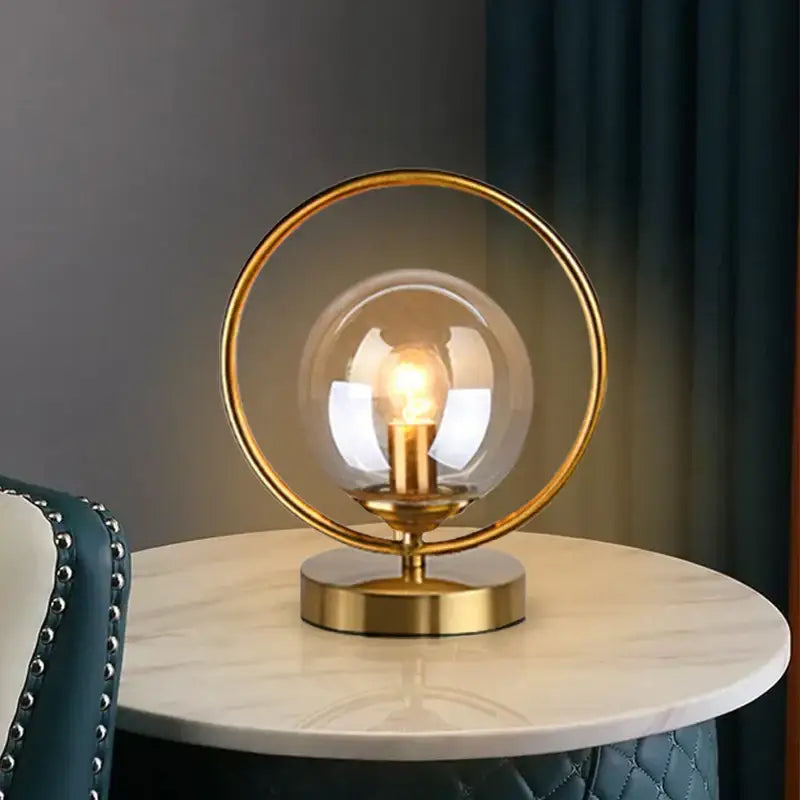Gold-toned decorbites led glass ball brass ring table lamp with clear globe and exposed filament bulb for stylish lighting