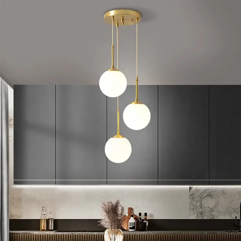 Gold-toned decorbites led glass ball chandelier with three frosted glass shades for dining room lighting