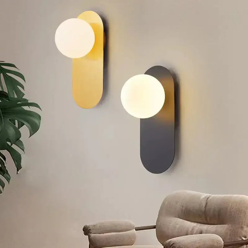 Modern decorbites led glass ball wall sconce with gold and matte black metallic bodies and soft-glowing spherical bulbs