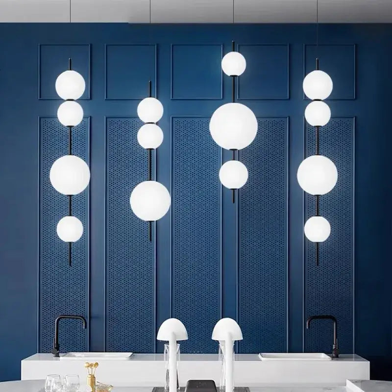 Modern white spherical decorbites led glass beads pendant chandelier with black rods against deep blue wall panels