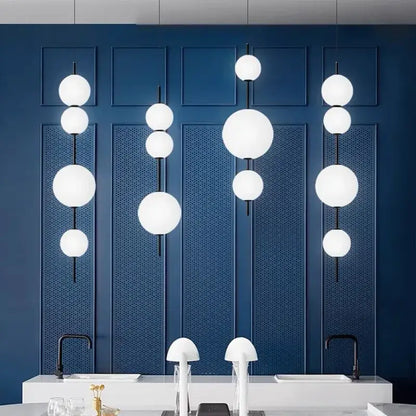 Modern white spherical decorbites led glass beads pendant chandelier with black rods against deep blue wall panels