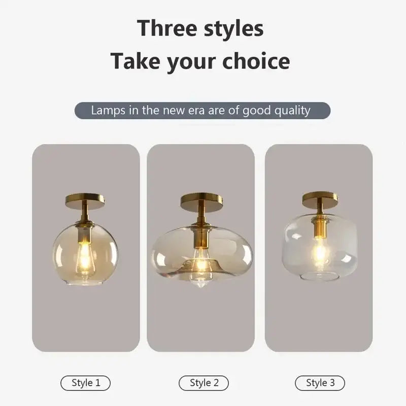Three modern decorbites led glass ceiling light pendant lamps with brass fixtures and clear and amber spherical shades