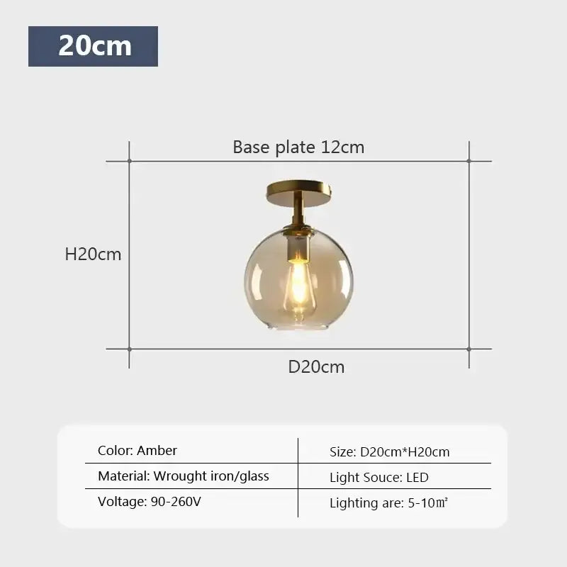 Amber-colored spherical decorbites led glass ceiling light with brass base and led bulb for modern living spaces