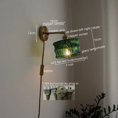 Green ribbed glass lampshade wall sconce with copper arm and canopy featuring pull chain switch for bedroom use