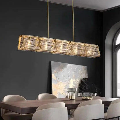 Gold-toned decorbites led glass pendant light with textured glass panels and hanging brass chains for kitchen island decor