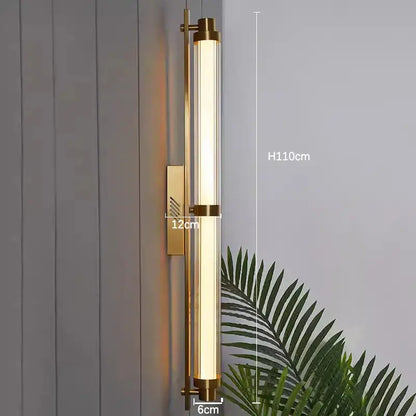 Gold-toned decorbites led glass wall lamp featuring a cylindrical glass tube and metallic frame for modern interiors