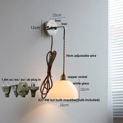 Decorbites led glass wall light features a minimalist frosted glass globe with polished iron bracket and adjustable copper wire