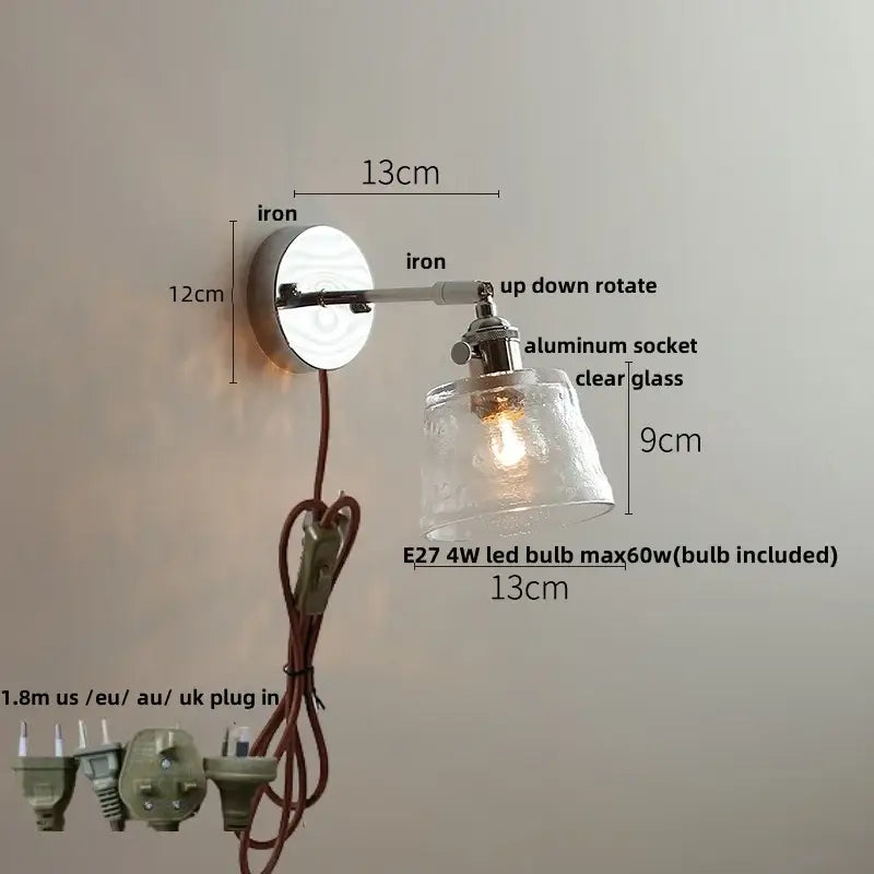 A sleek decorbites led glass wall light with polished iron base and clear shade featuring e27 4w led bulb