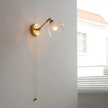 Gold-toned DecorBites™ LED glass wall light fixture with translucent flower shade and adjustable arm for modern living room use