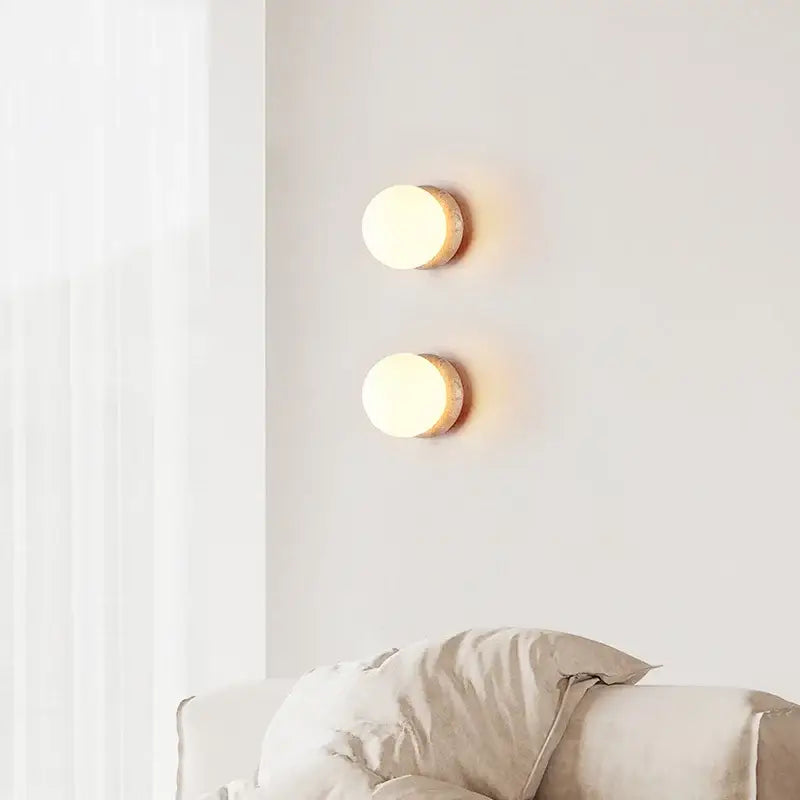 Two warm-toned circular decorbites led glass wall lights with rustic wood finish and pull chain switch for living room