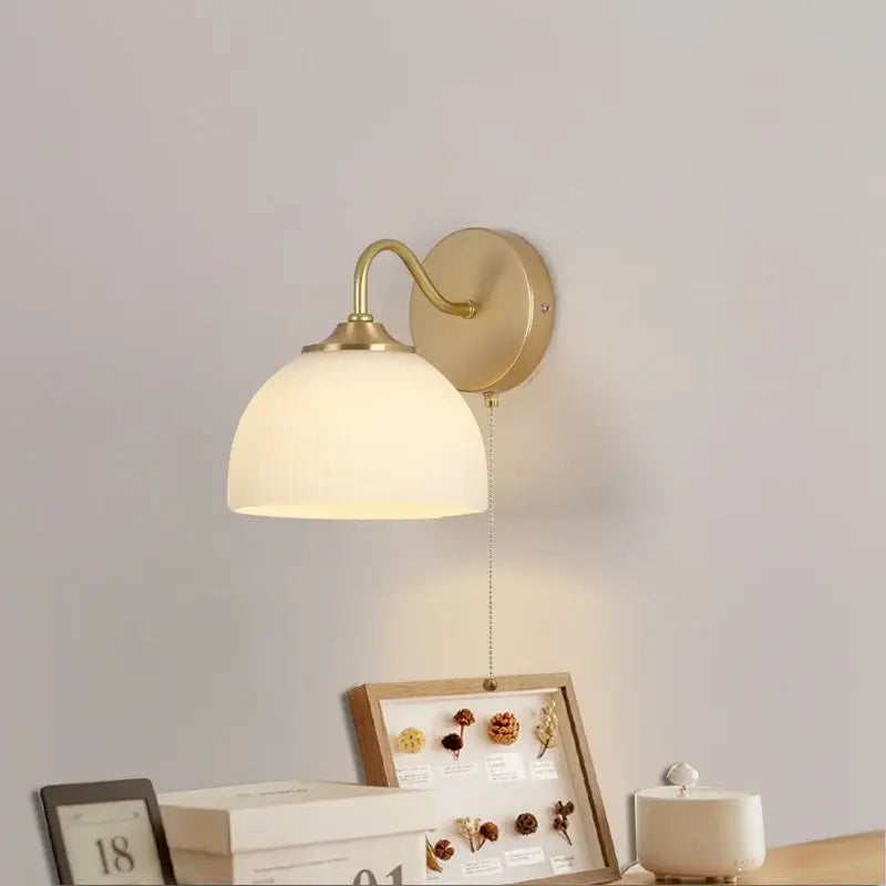 Brass-finished decorbites led glass wall sconce with ribbed off-white glass shade and pull chain switch for stairs