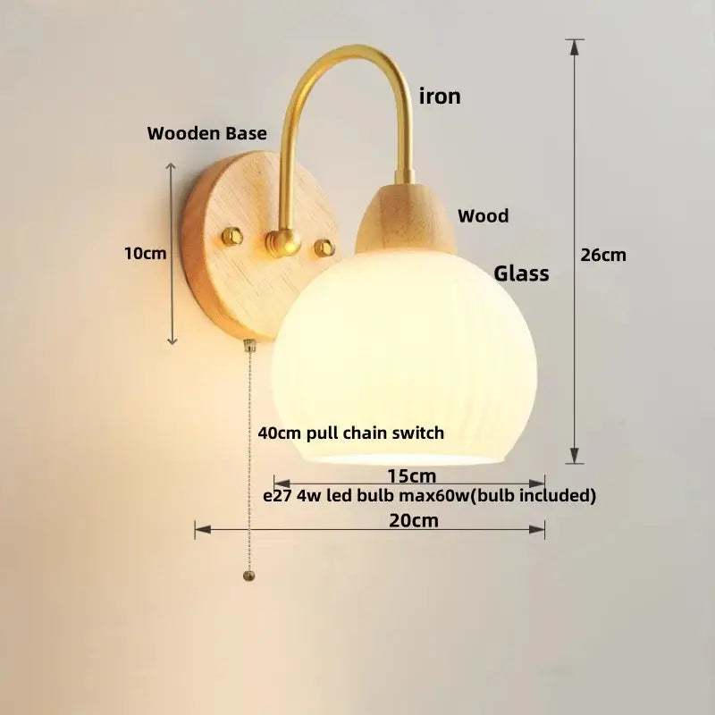 DecorBites led glass wall sconce with warm-toned glass globe, brass iron arm, wooden base, and 4w led bulb included