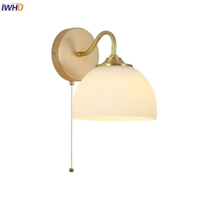 Gold-toned decorbites led glass wall sconce with ribbed off-white glass shade and pull-chain switch for stair lighting
