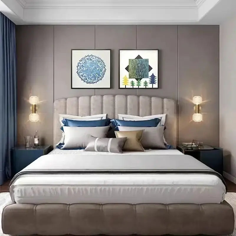 Beige tufted upholstered bed with blue gray gold pillows complemented by gold decorbites™ led glass wall sconces for home lighting