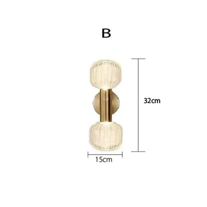 Gold-toned DecorBites™ LED glass wall sconces featuring two faceted translucent glass globes for home lighting