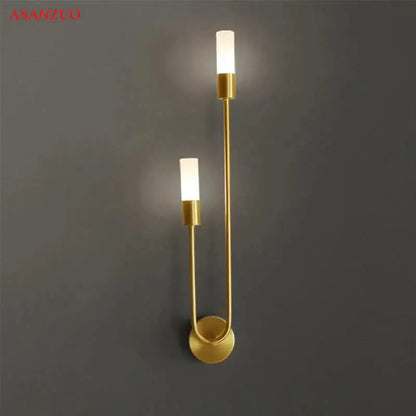 Decorbites led gold candlestick wall light with two vertical cylindrical fixtures and sleek curved metal frame for indoor decor