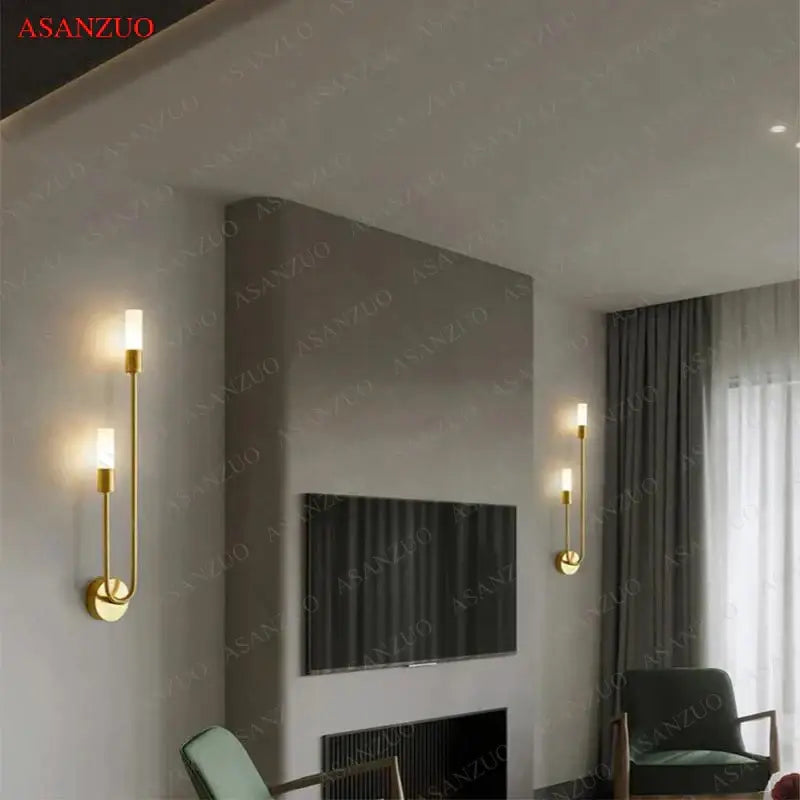 Gold-toned DecorBites LED candlestick wall light with sleek curved arms and frosted glass shades for indoor ambiance