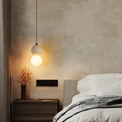 A warm glowing pendant light with frosted glass globe and metal chain decorbites led gourd pendant for living rooms