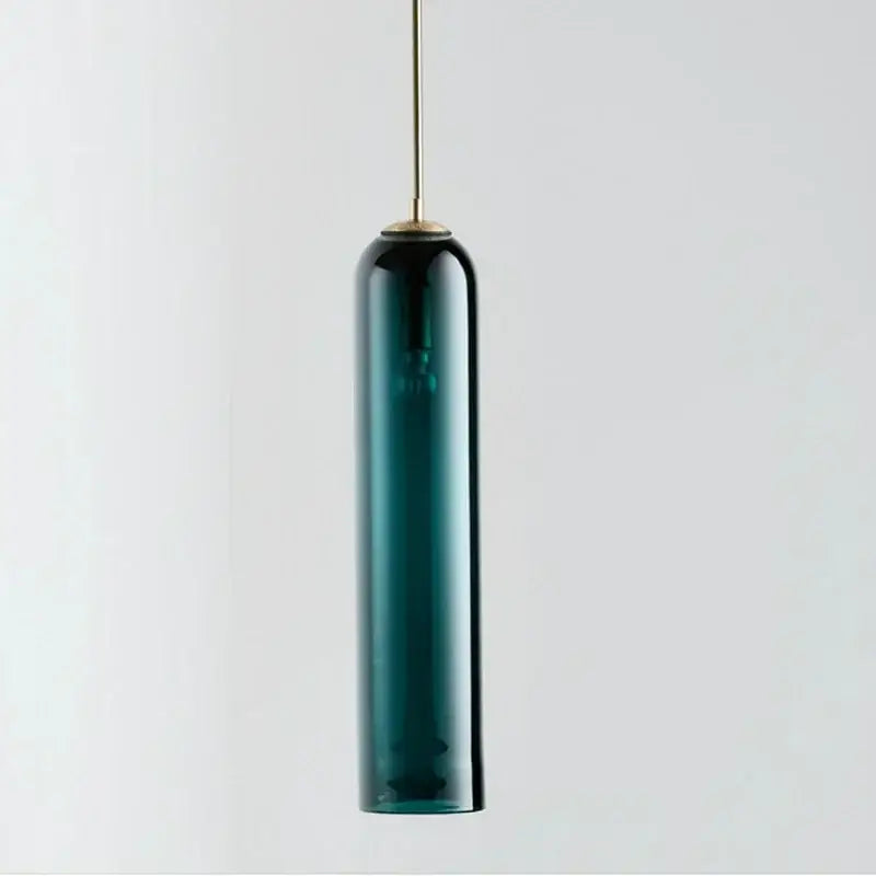 A sleek decorbites led green pendant light with deep teal glass shade and brass metal stem for kitchen bar decor