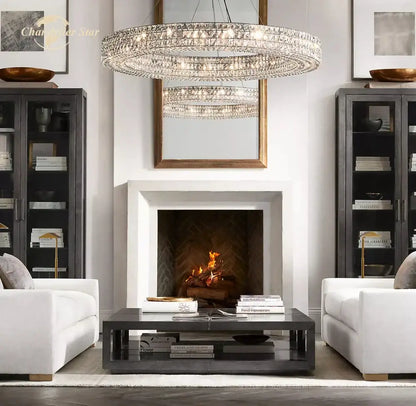 A multi-tiered decorbites led halo crystal chandelier with circular design hangs above a fireplace for modern decor