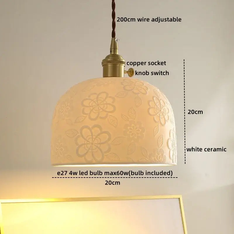 A cream ceramic decorbites led hanging lamp with floral embossing and brass-finished copper socket for living room
