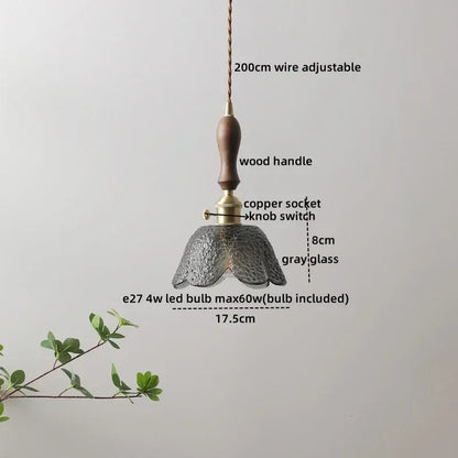 A delicate gray glass decorbites led hanging light with textured petals and wooden handle for modern living spaces