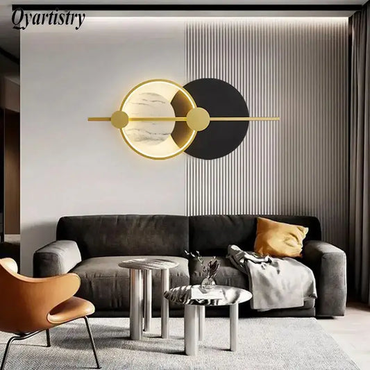 Modern gold-toned decorbites led home wall lamp with circular marble-like and black panels for living room lighting