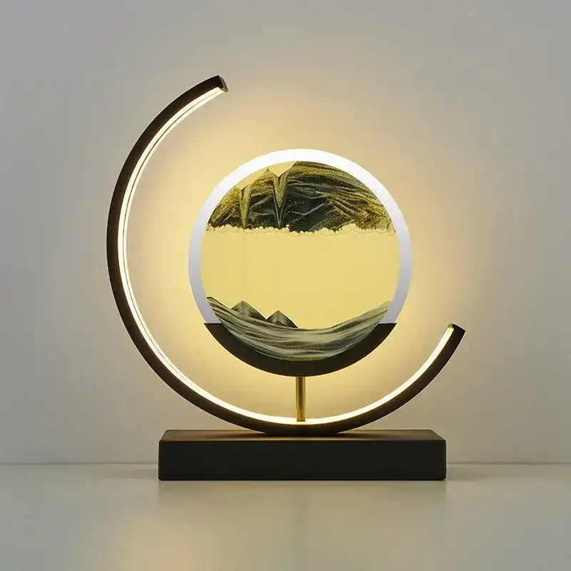 Modern crescent-shaped DecorBites LED hourglass with circular sand art in black metal frame for desk lighting and decor