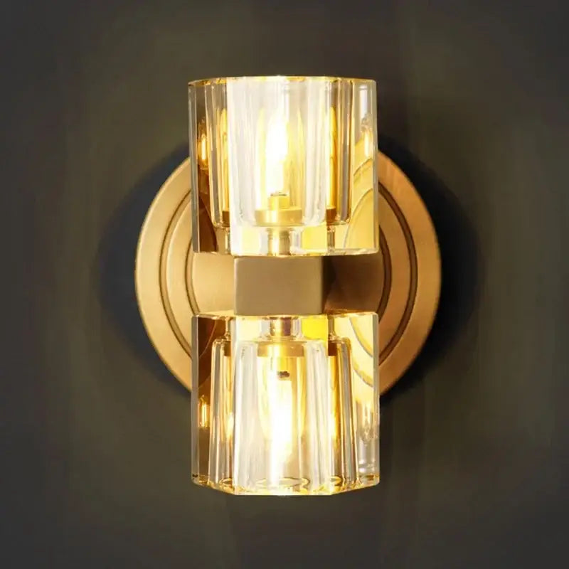 Gold-toned decorbites led indoor wall sconce with stacked clear glass cylinders for indoor bedside lamp use