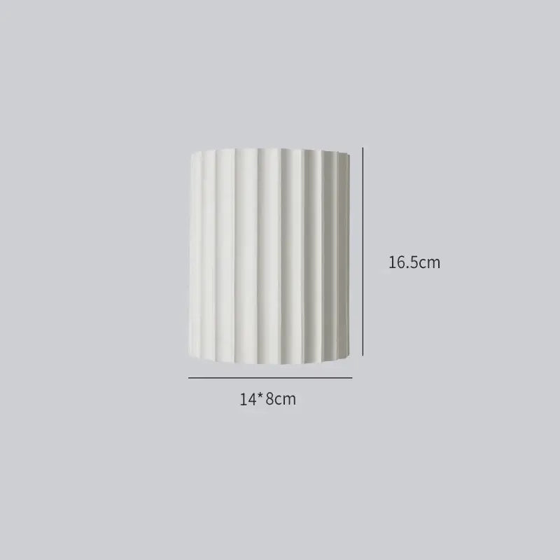 A sleek white cylindrical decorbites led indoor wall lamp with vertical ridges for living room and bedroom lighting