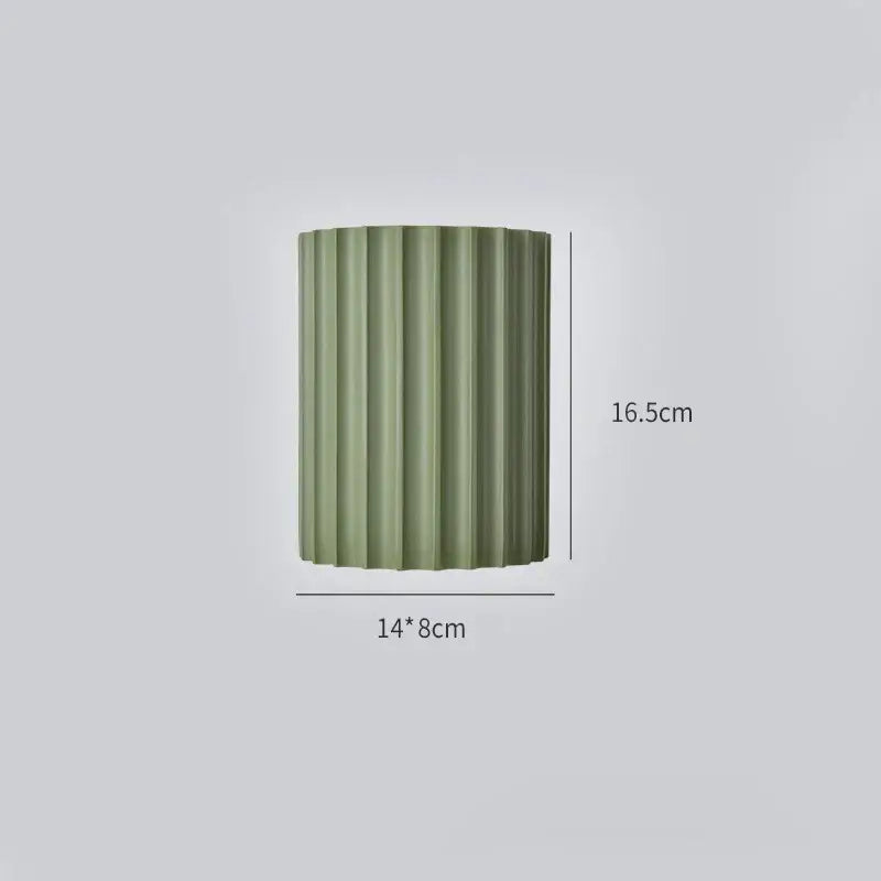 Olive green ribbed cylindrical vase paired with decorbites led indoor wall lamp for home and bedside lighting