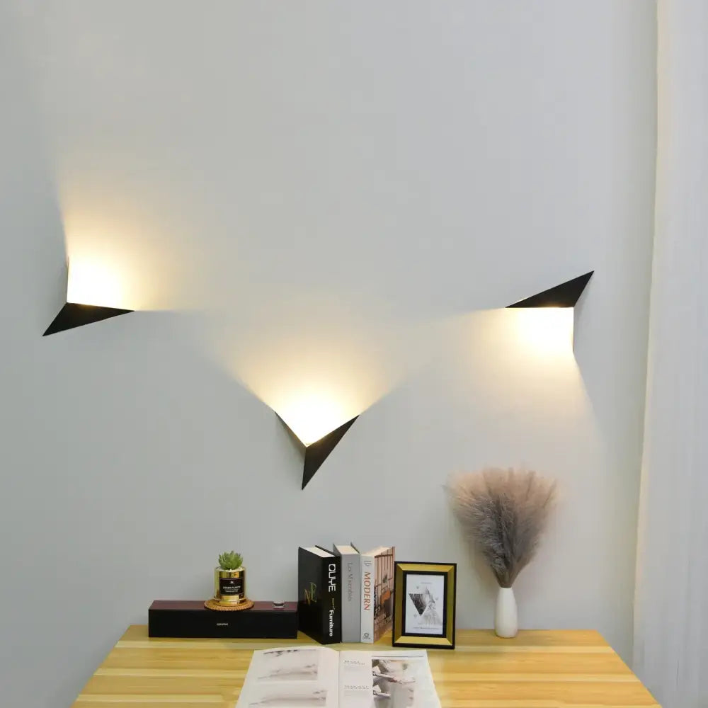 Black geometric decorbites led indoor wall lamp with angular triangular design emitting warm light for home decor