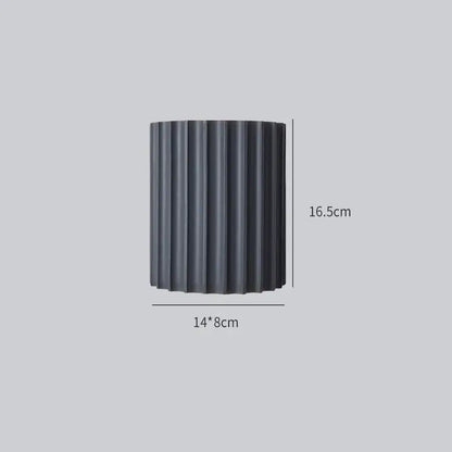 Black cylindrical planter with vertical ridges 14cm wide 16.5cm tall featured in decorbites led indoor wall lamp setup