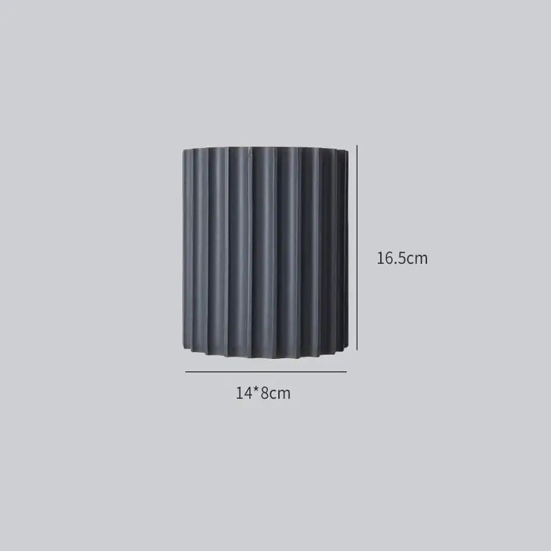 Black cylindrical planter with vertical ridges 14cm wide 16.5cm tall featured in decorbites led indoor wall lamp setup