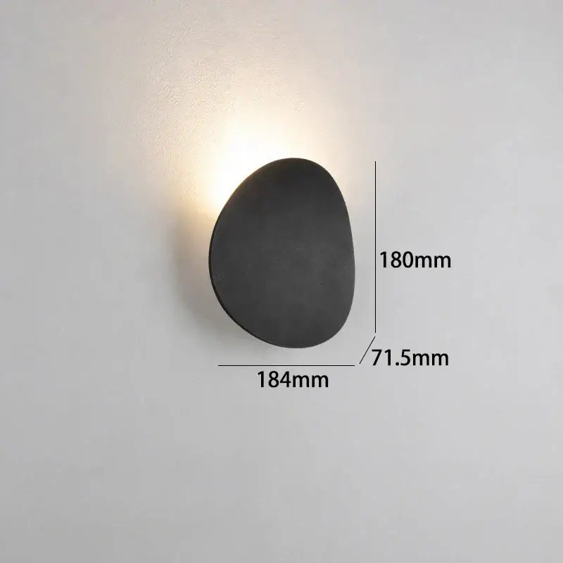 Black matte-finished organic egg-shaped DecorBites™ LED indoor wall lamp for living room and bedside lighting