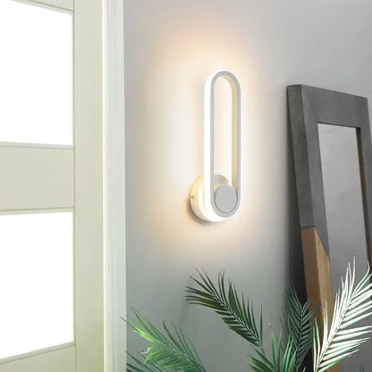 Modern white decorbites led indoor wall lamp with sleek elongated oval design and circular base for home lighting