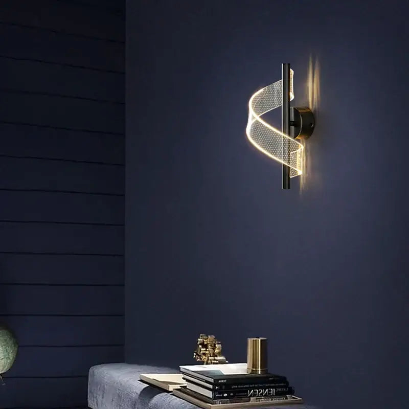 DecorBites™ LED indoor wall sconce light with a twisted illuminated mesh band in warm gold and matte black base
