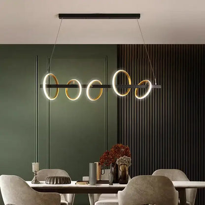Modern minimalist decorbites led industrial chandelier with five glowing gold and black circular rings for dining room