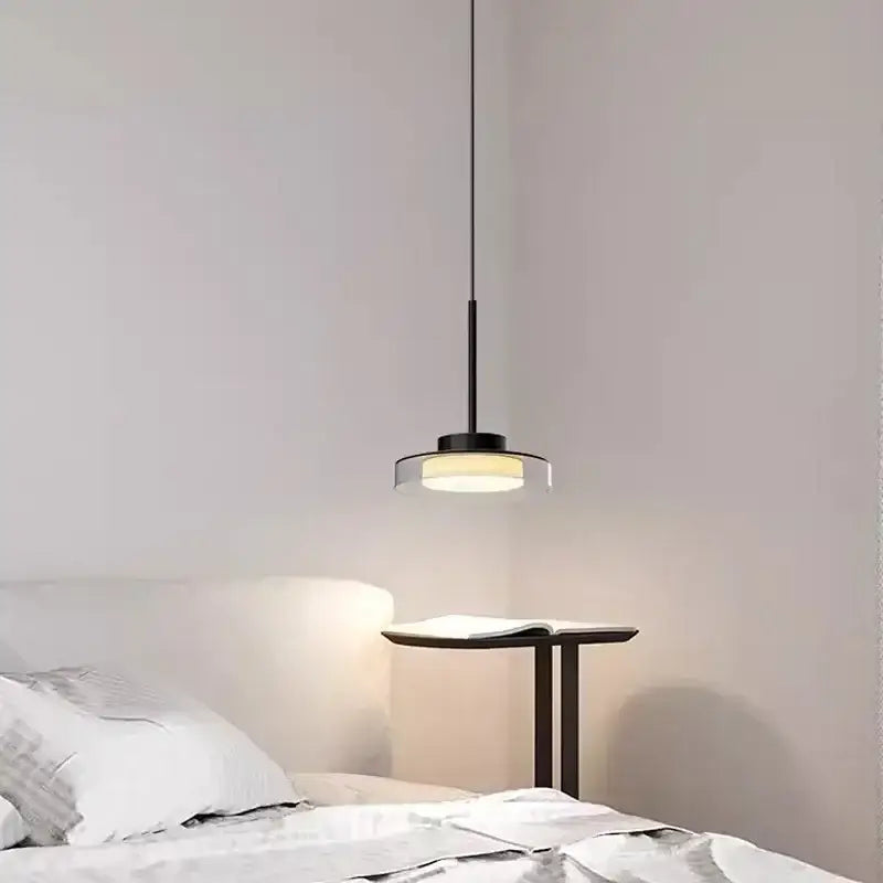 Minimalist black decorbites led iron acrylic pendant with circular glass shade emitting warm light for bedroom and living room