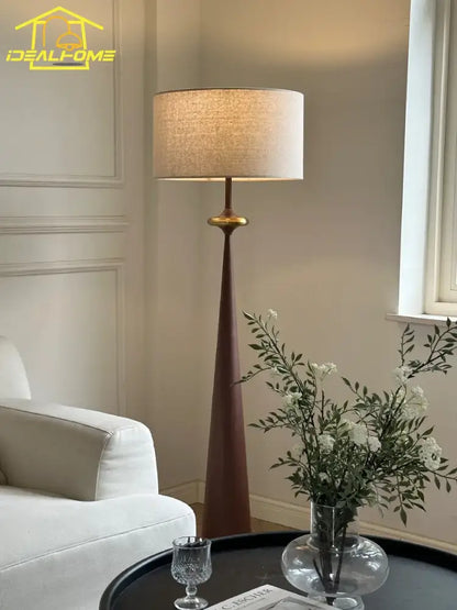 Tall slender decorbites led iron floor lamp with warm beige fabric shade and dark wood base for living room or bedroom
