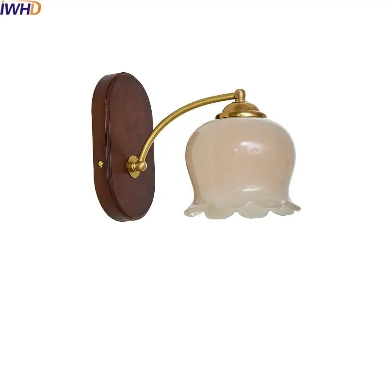 Vintage-style decorbites led japanese wall light with warm brass arm and frosted glass shade on dark wood backplate