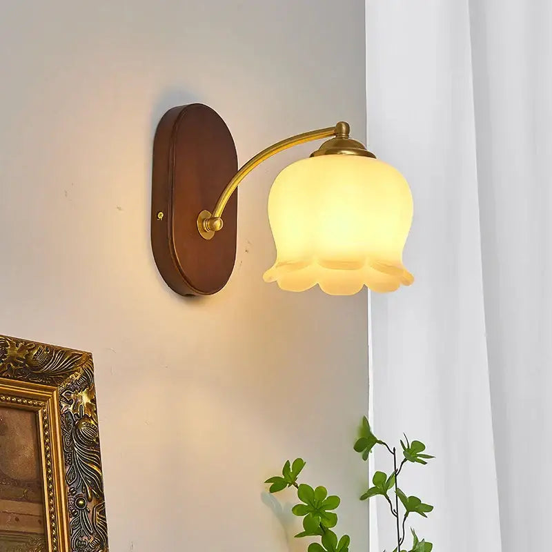 Warm-toned frosted glass bell-shaped decorbites led japanese style wall lights with brass arm and dark wood backplate