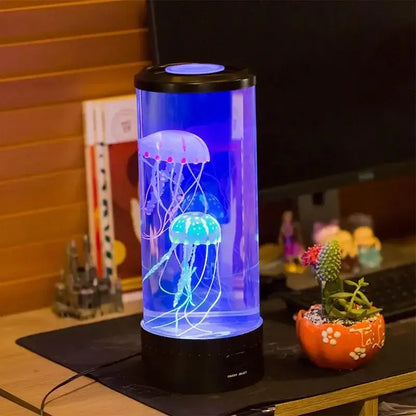 A decorbites led jellyfish lamp with glowing blue and purple translucent jellyfish in a cylindrical glass aquarium