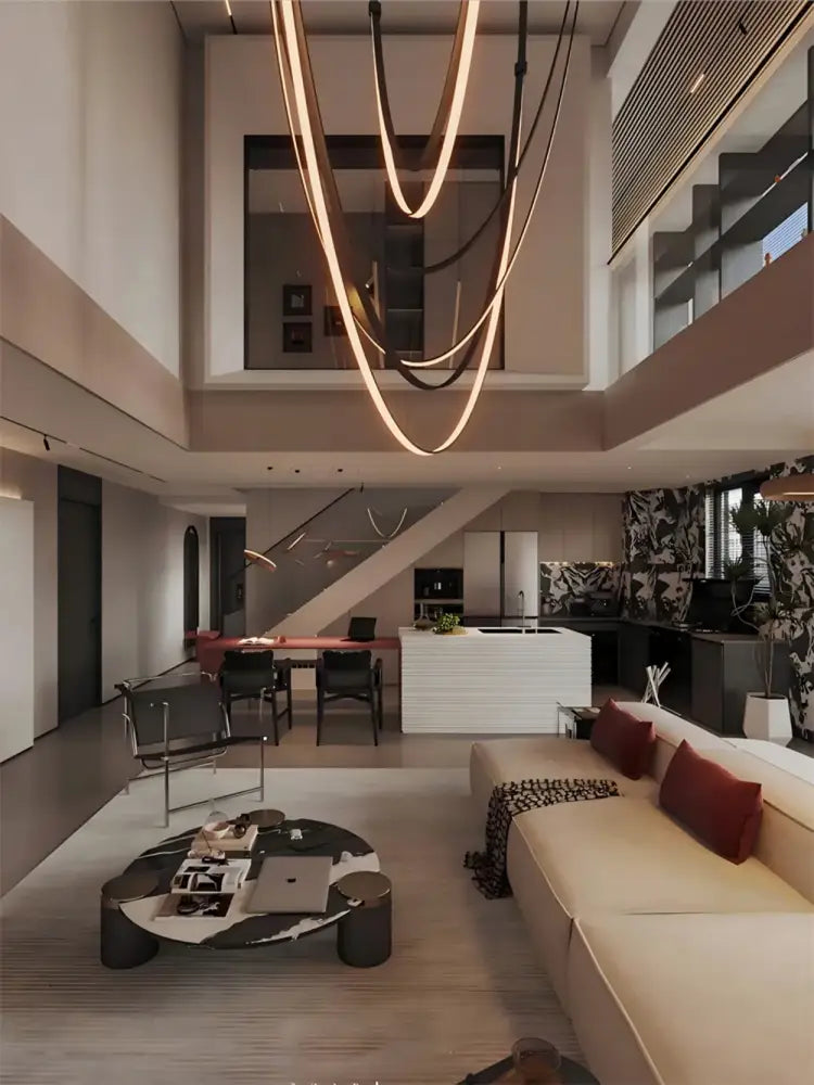 A modern living room coffee table with a sleek black and white marble top and dark metal legs next to a trendy diy flexible leather belt chandelier